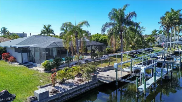 a view of a house with swimming pool and sitting area