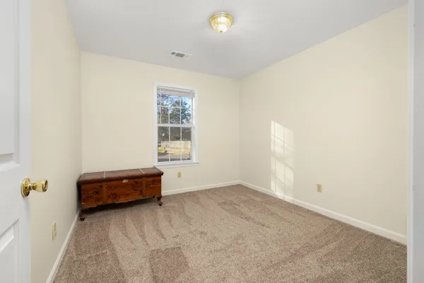 a view of a house with a yard and wooden fence