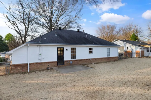 a bed room with a bed and a chair