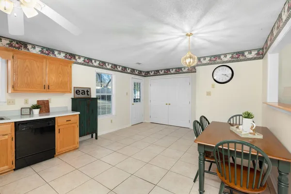 a kitchen with stainless steel appliances kitchen island granite countertop a sink and cabinets