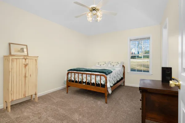 a bedroom with a bed and a computer on a table