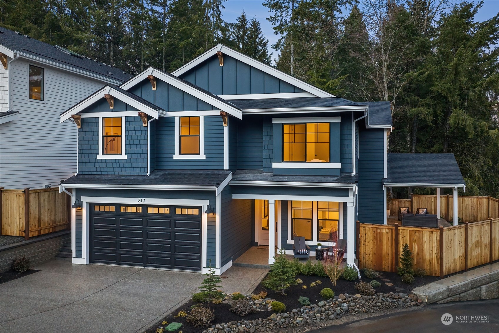 317 174th Street Southeast Bothell, WA 98012 - Photo 1 of 37 a front view of a house with glass windows and potted plants
