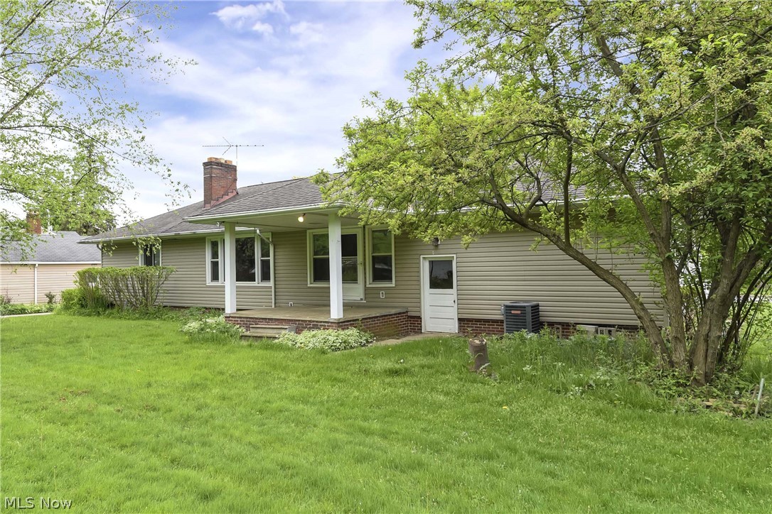 14593 Turney Road Maple Heights, OH 44137 - Photo 33 of 45 Rear view of property with a yard, central AC unit, and a patio