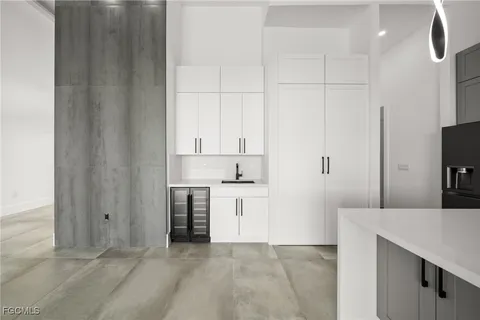 a kitchen with kitchen island a sink appliances and cabinets