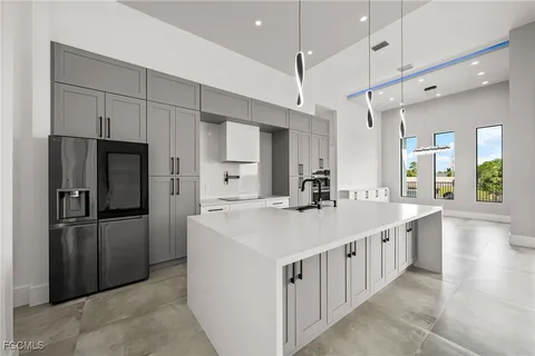 a kitchen with kitchen island white cabinets and stainless steel appliances