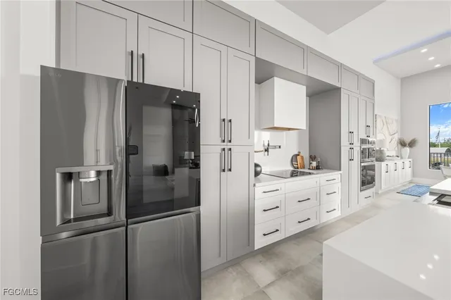 a kitchen with cabinets and stainless steel appliances