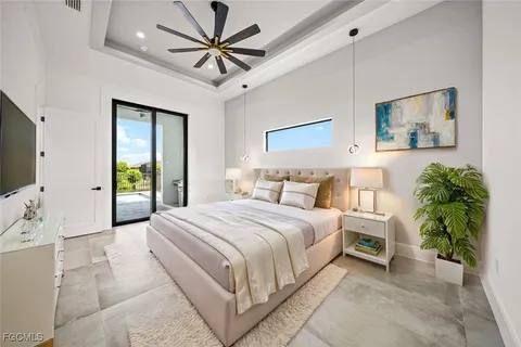 an empty room with a ceiling fan and a window