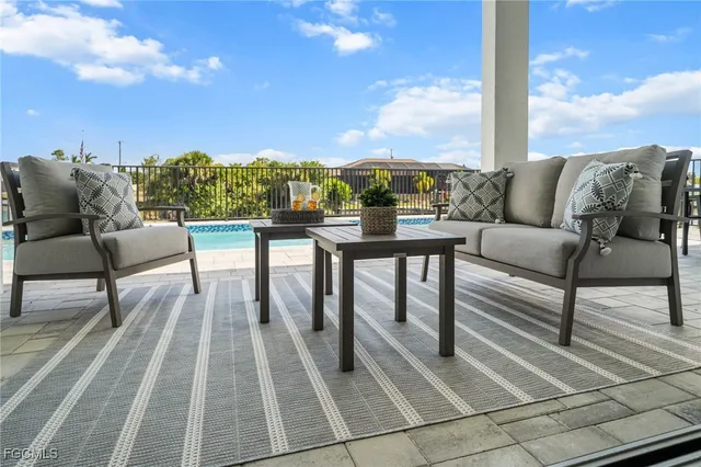 a view of a house with backyard porch and sitting area