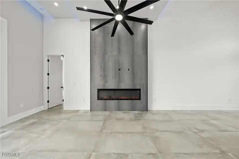 a view of a hallway with wooden floor and a large window