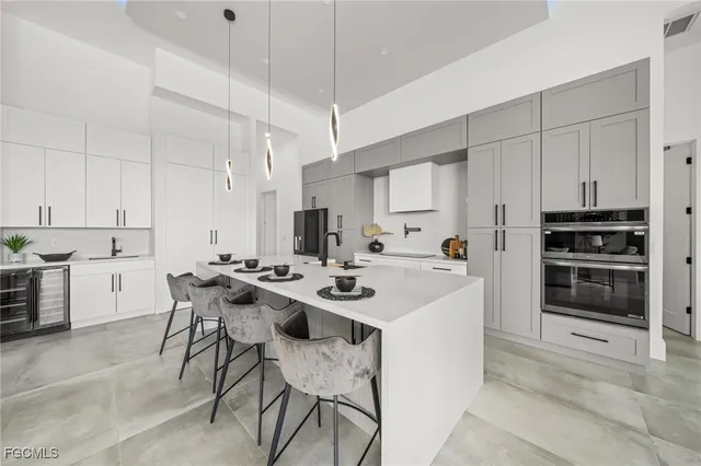 a kitchen with a sink a white stove cabinets and a chairs