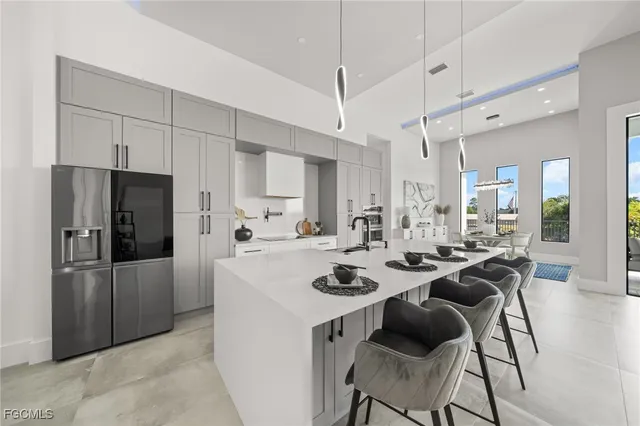 a kitchen with a refrigerator a stove a dining table and chairs