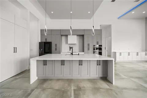 a view of a kitchen with white cabinets