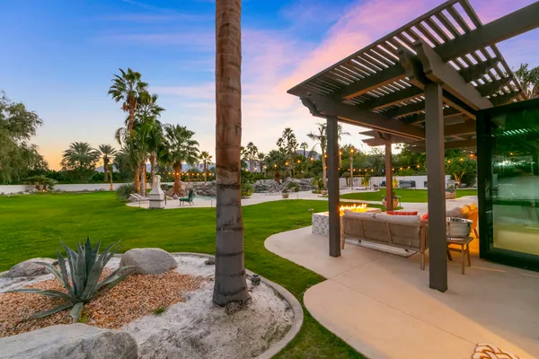 an aerial view of a house with swimming pool patio and outdoor seating