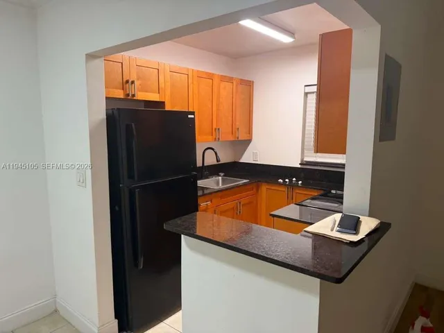 a kitchen with a sink and a refrigerator