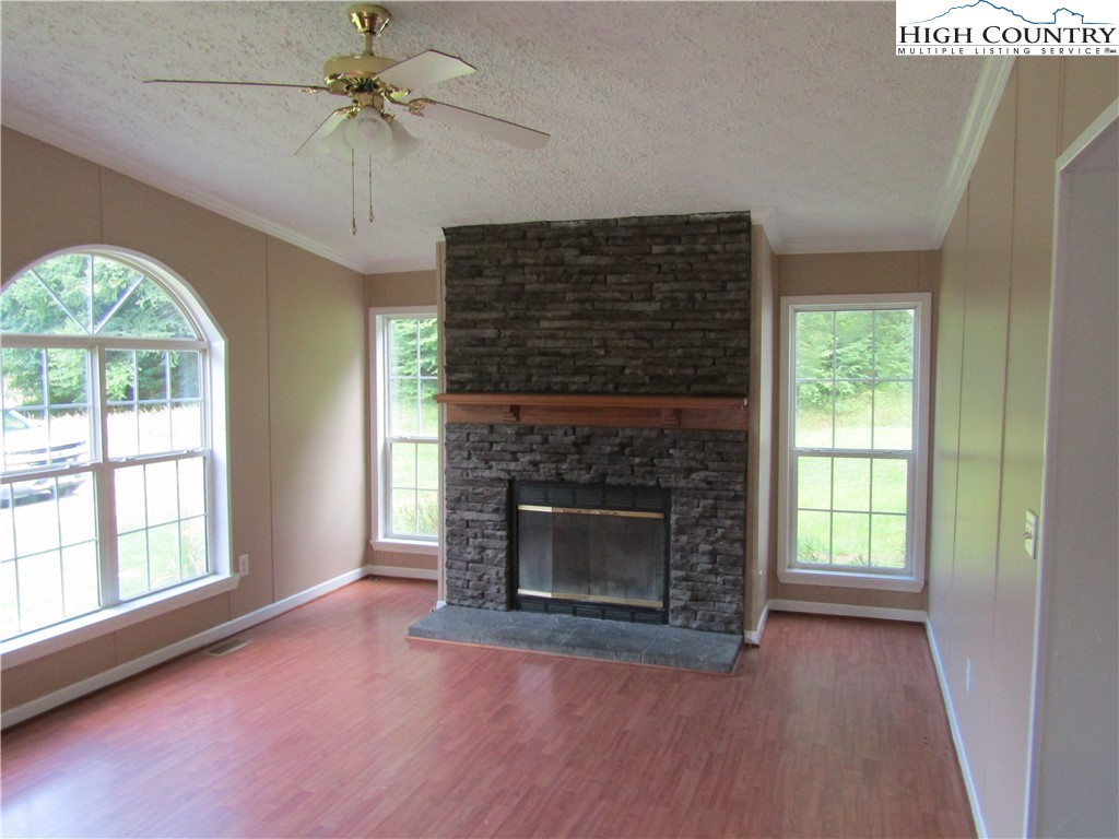 311 Walter Blevins Road Lansing, NC 28643 - Photo 11 of 22 a view of an empty room with a fireplace and a window