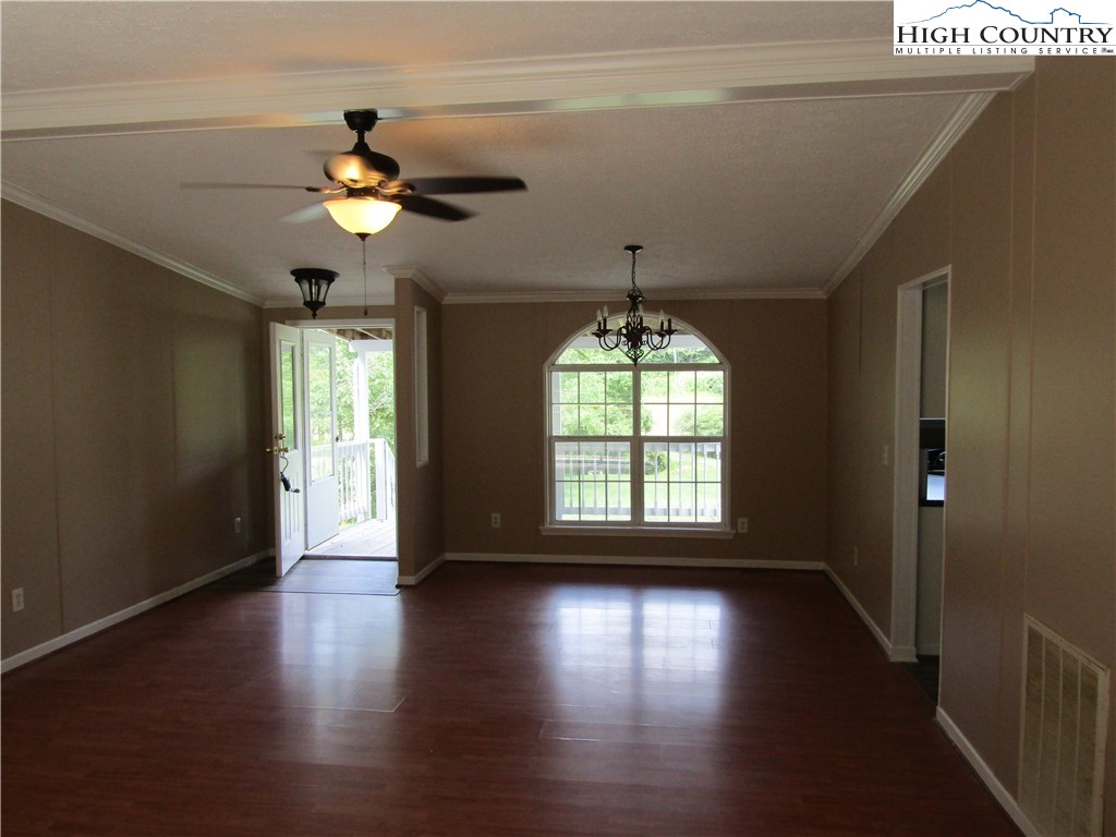 311 Walter Blevins Road Lansing, NC 28643 - Photo 10 of 22 a view of an empty room with wooden floor and a window