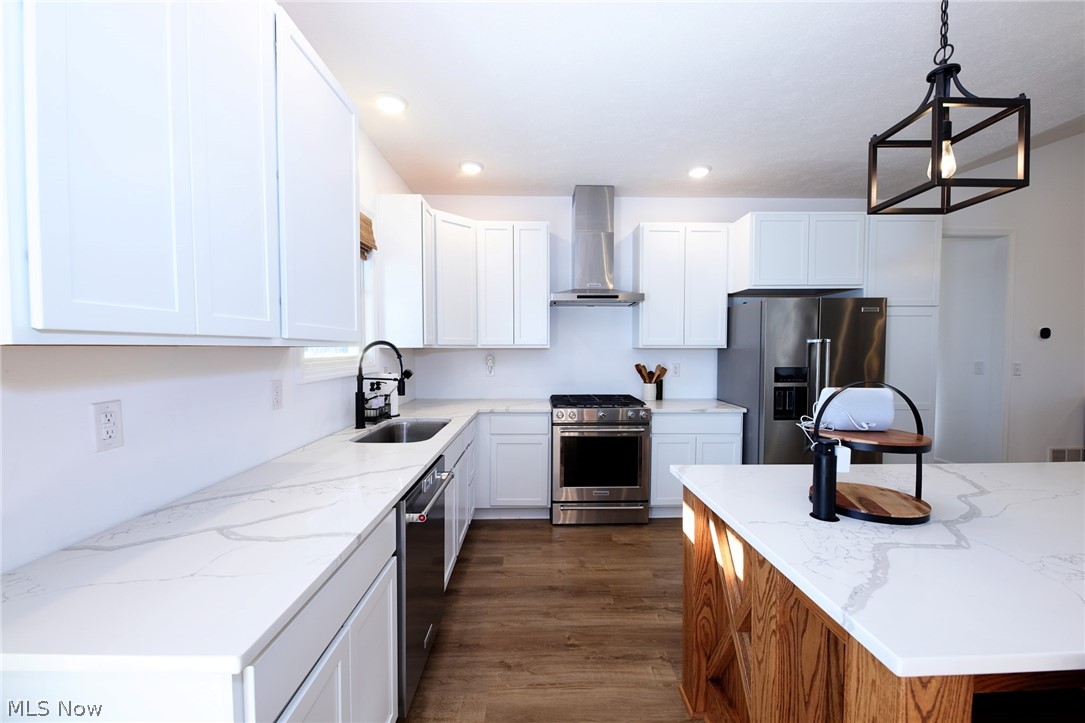 258 Friendly Acres Road Wellsburg, WV 26070 - Photo 4 of 47 Eat-In Kitchen featuring stainless steel appliances, cabinets, wood-style floors, and hanging lights