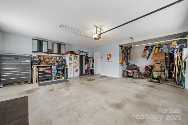 a view of a hallway with couches and a chandelier