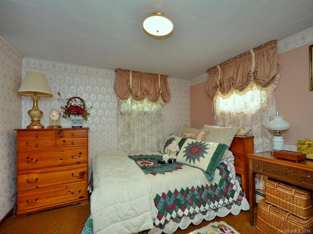 160 School House Branch Road Canton, NC 28716 - Photo 8 of 15 a bedroom with a bed and a window