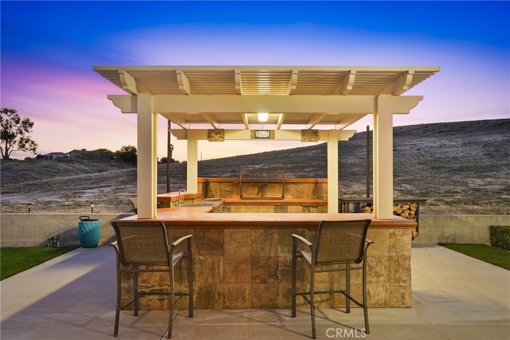 220 Cook Court Templeton, CA 93465 - Photo 34 of 45 a view of a patio with table and chairs under an umbrella next to an ocean