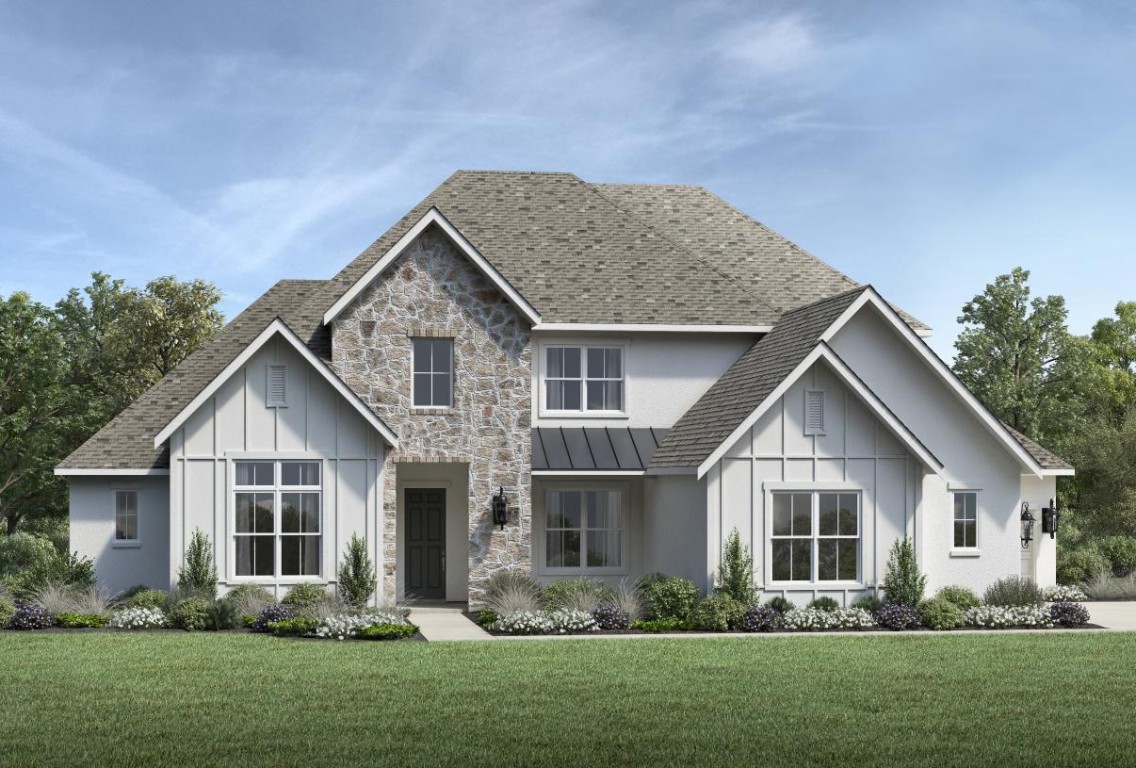a front view of a house with a yard and green space