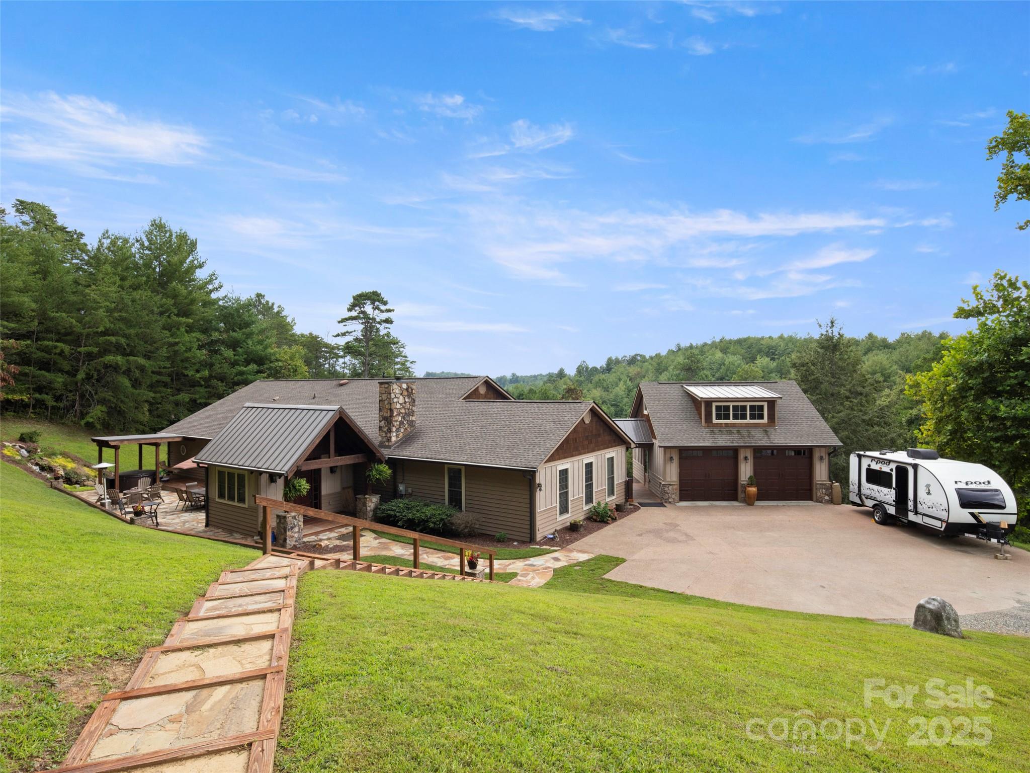 298 Lone Pine Road Alexander, NC 28701 - Photo 2 of 48 a front view of a house with a garden and deck