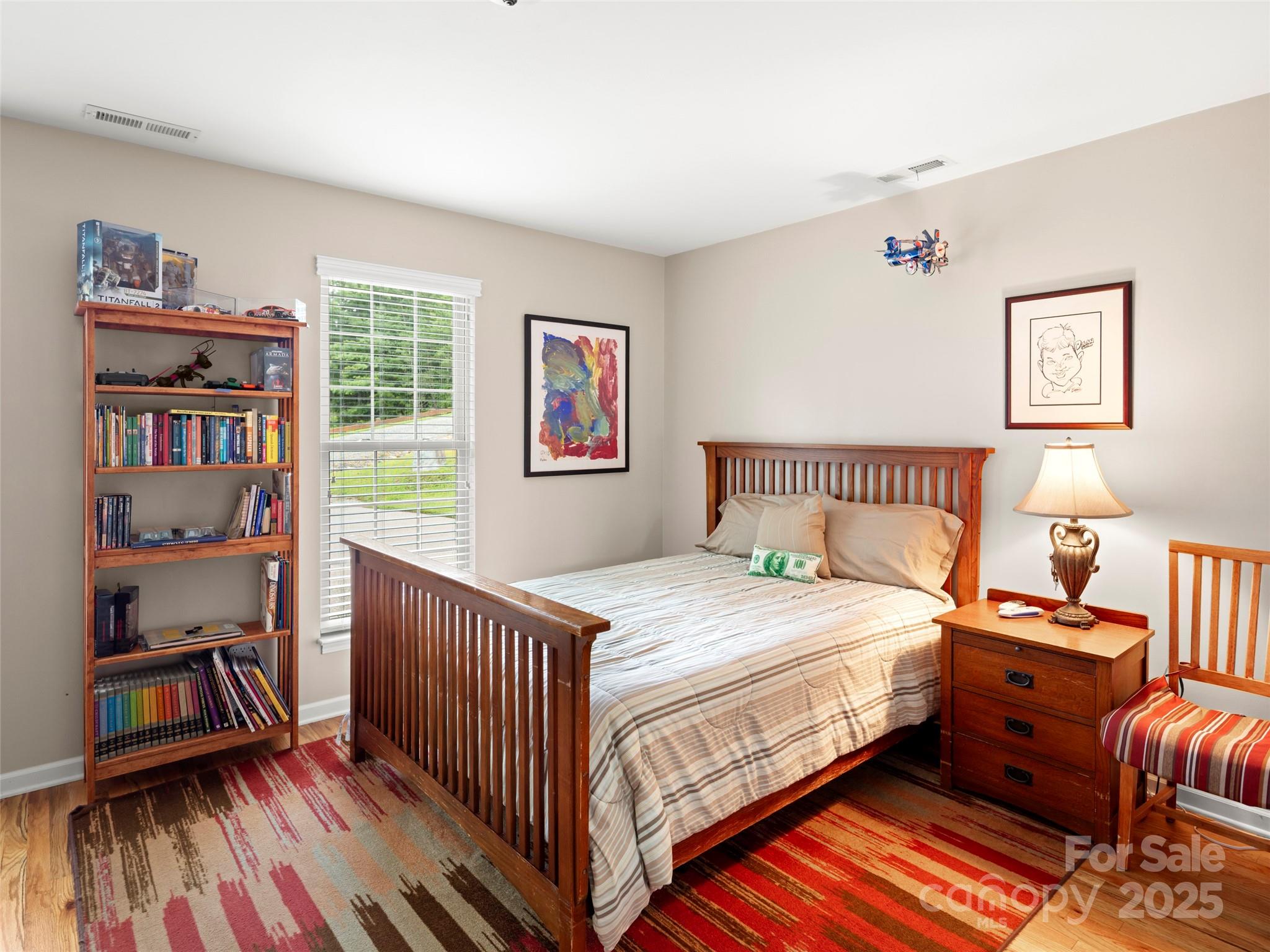 298 Lone Pine Road Alexander, NC 28701 - Photo 27 of 48 a bedroom with a bed and a book shelf