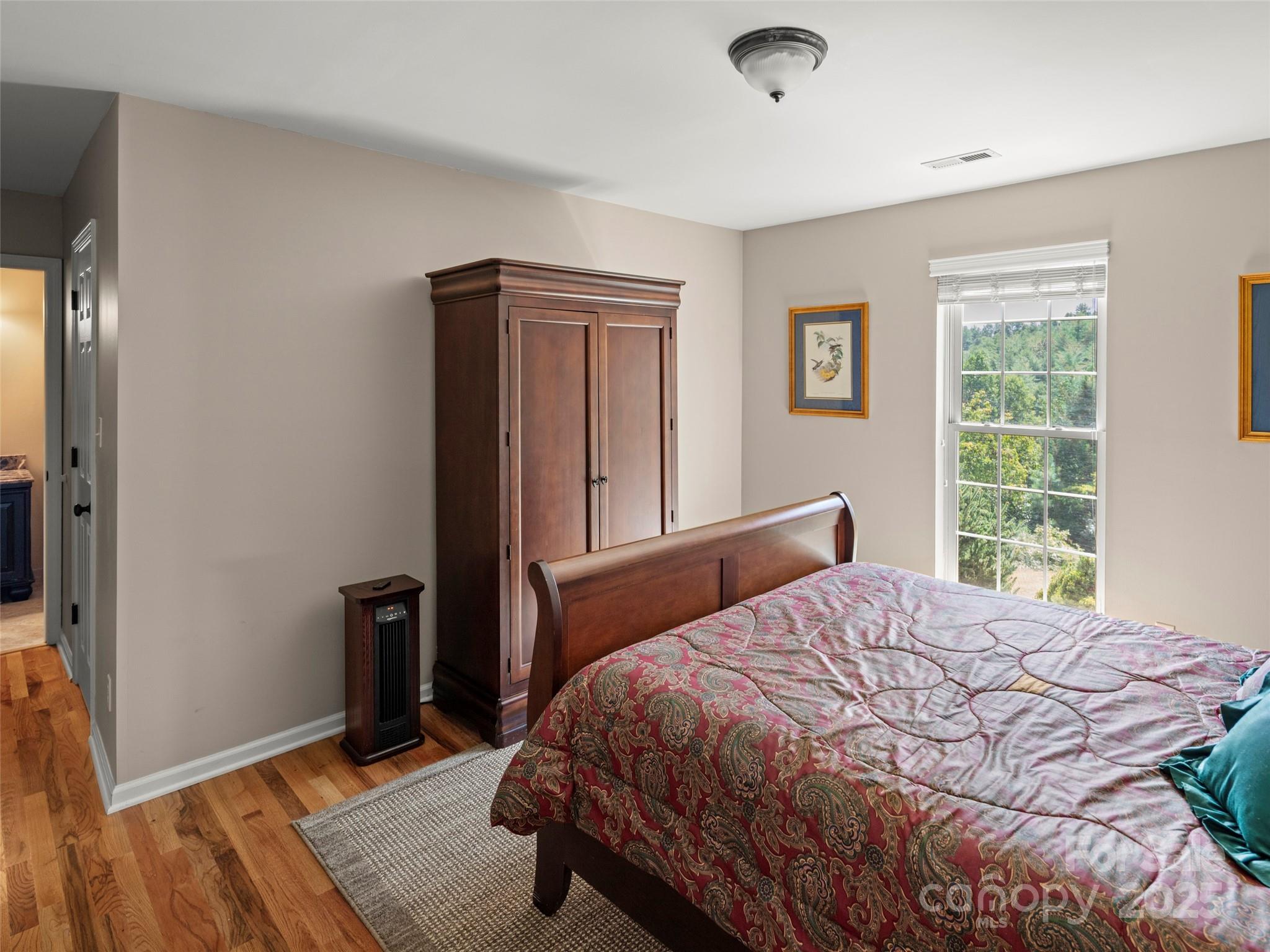 298 Lone Pine Road Alexander, NC 28701 - Photo 29 of 48 a bedroom with a bed and wooden floor