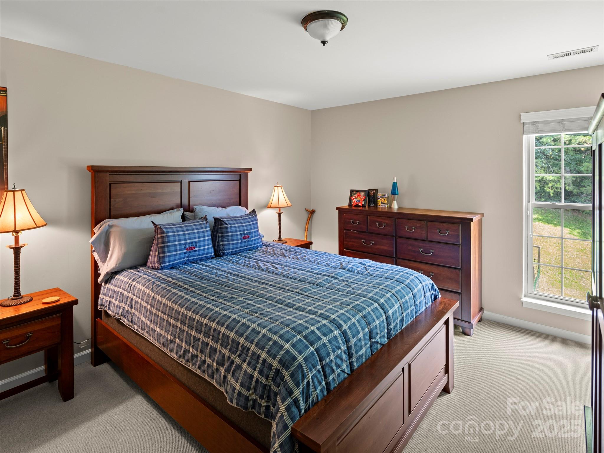 298 Lone Pine Road Alexander, NC 28701 - Photo 31 of 48 a bedroom with bed and a window