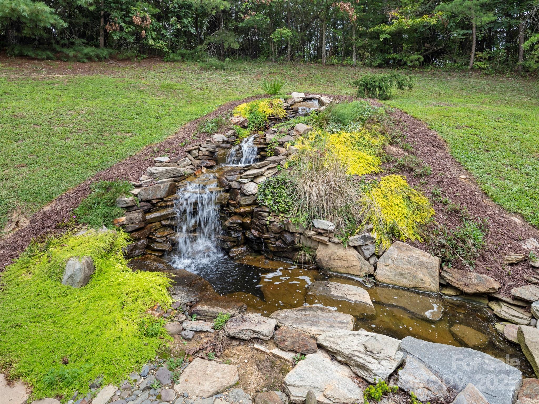 298 Lone Pine Road Alexander, NC 28701 - Photo 34 of 48 a view of a lake with a yard