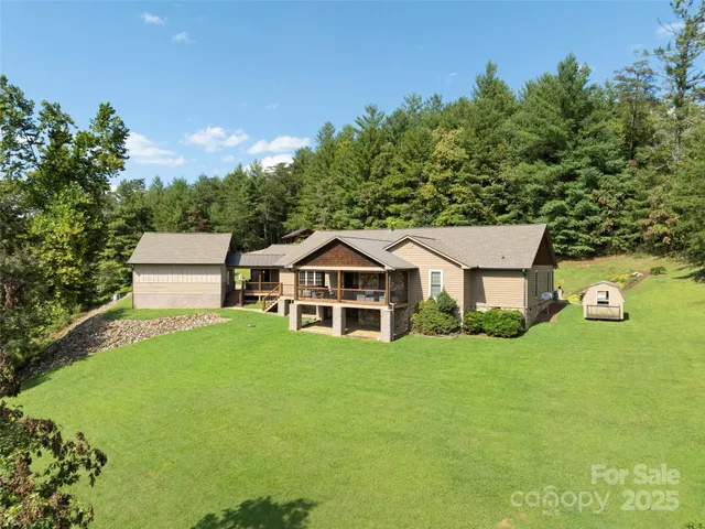 a big white house with a yard and plants