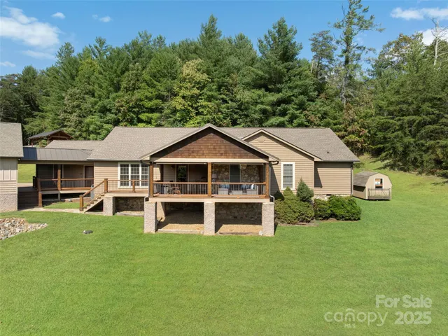 a front view of a house with a yard and potted plants