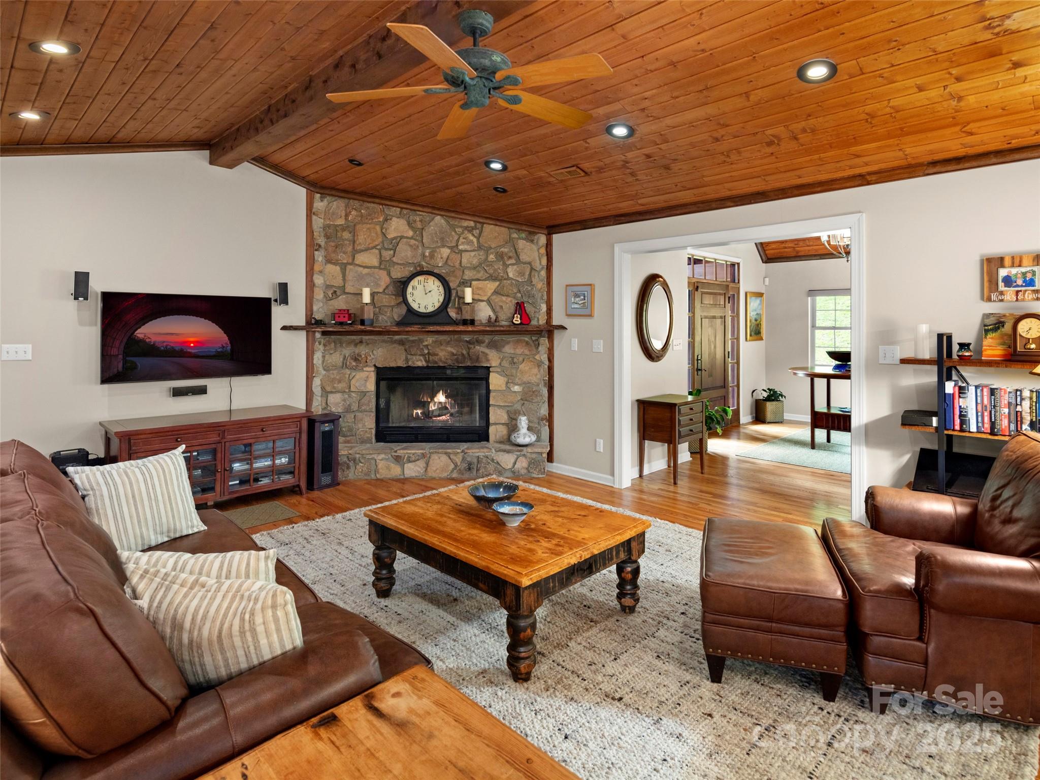 298 Lone Pine Road Alexander, NC 28701 - Photo 10 of 48 a living room with furniture a fireplace and a flat screen tv