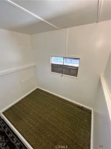 a view of a room with wooden floor and cabinet