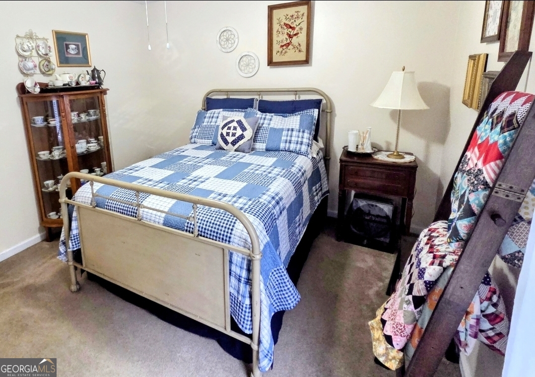 21 Baskin Heights Path Temple, GA 30179 - Photo 26 of 44 a bed sitting in a bedroom next to a book shelf