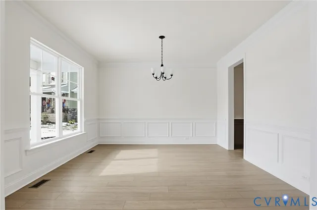 a kitchen with stainless steel appliances granite countertop a stove top oven a sink dishwasher and a refrigerator with wooden floor