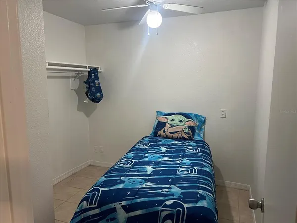 a bedroom with a bed and a chandelier