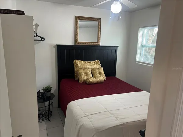 a bedroom with a bed and a window