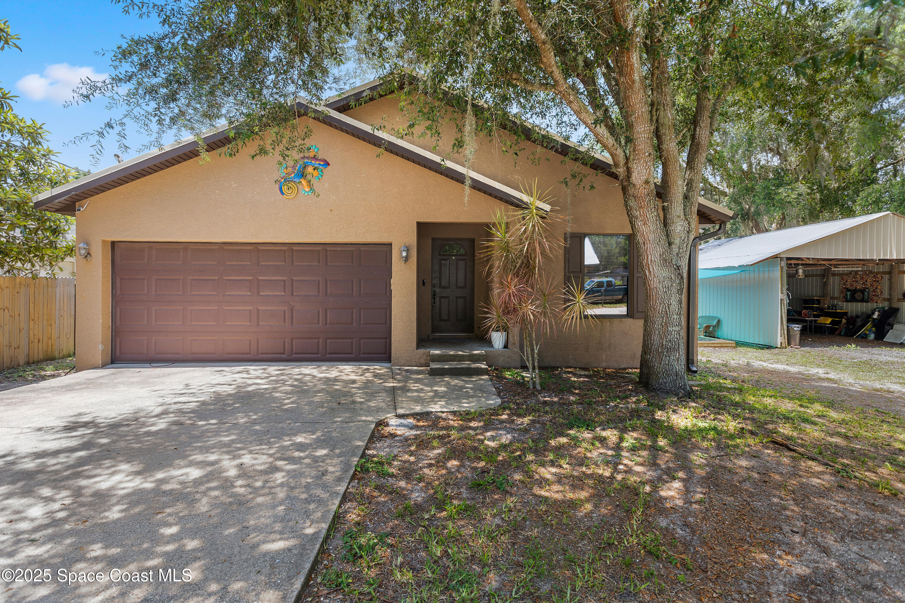 5964 Travis Street Mims, FL 32754 - Photo 1 of 45 a view of a house with a yard