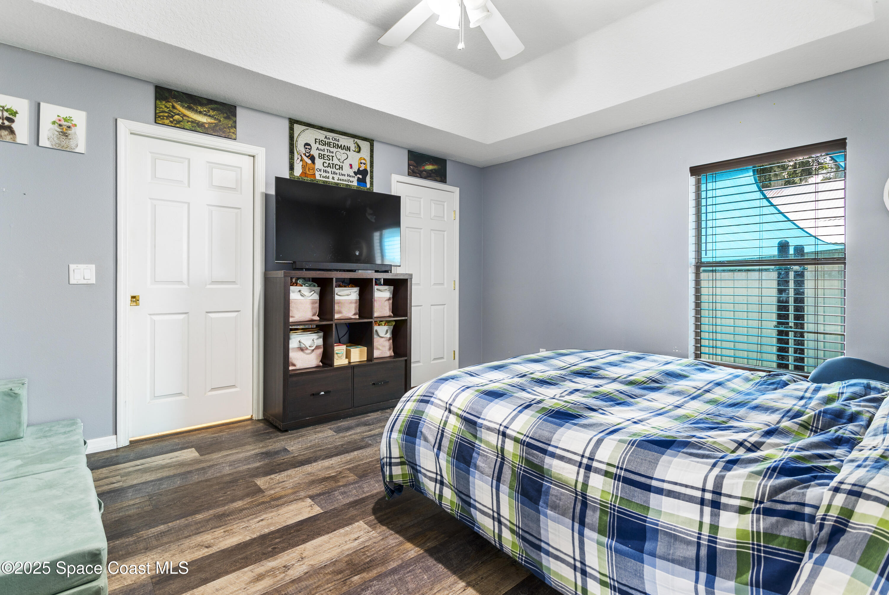 5964 Travis Street Mims, FL 32754 - Photo 14 of 45 a bedroom with a bed and a flat tv screen on dresser