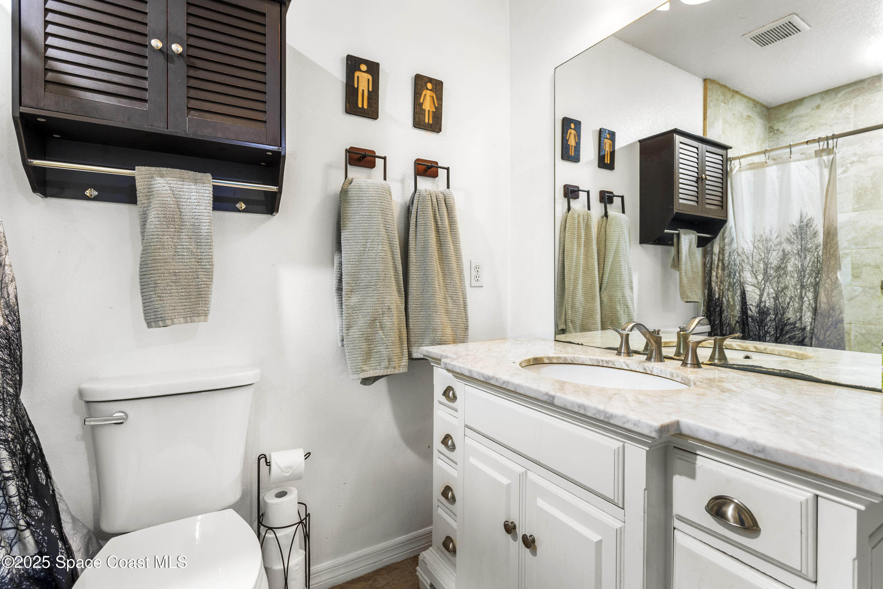 5964 Travis Street Mims, FL 32754 - Photo 16 of 45 a bathroom with a granite countertop sink toilet and shower