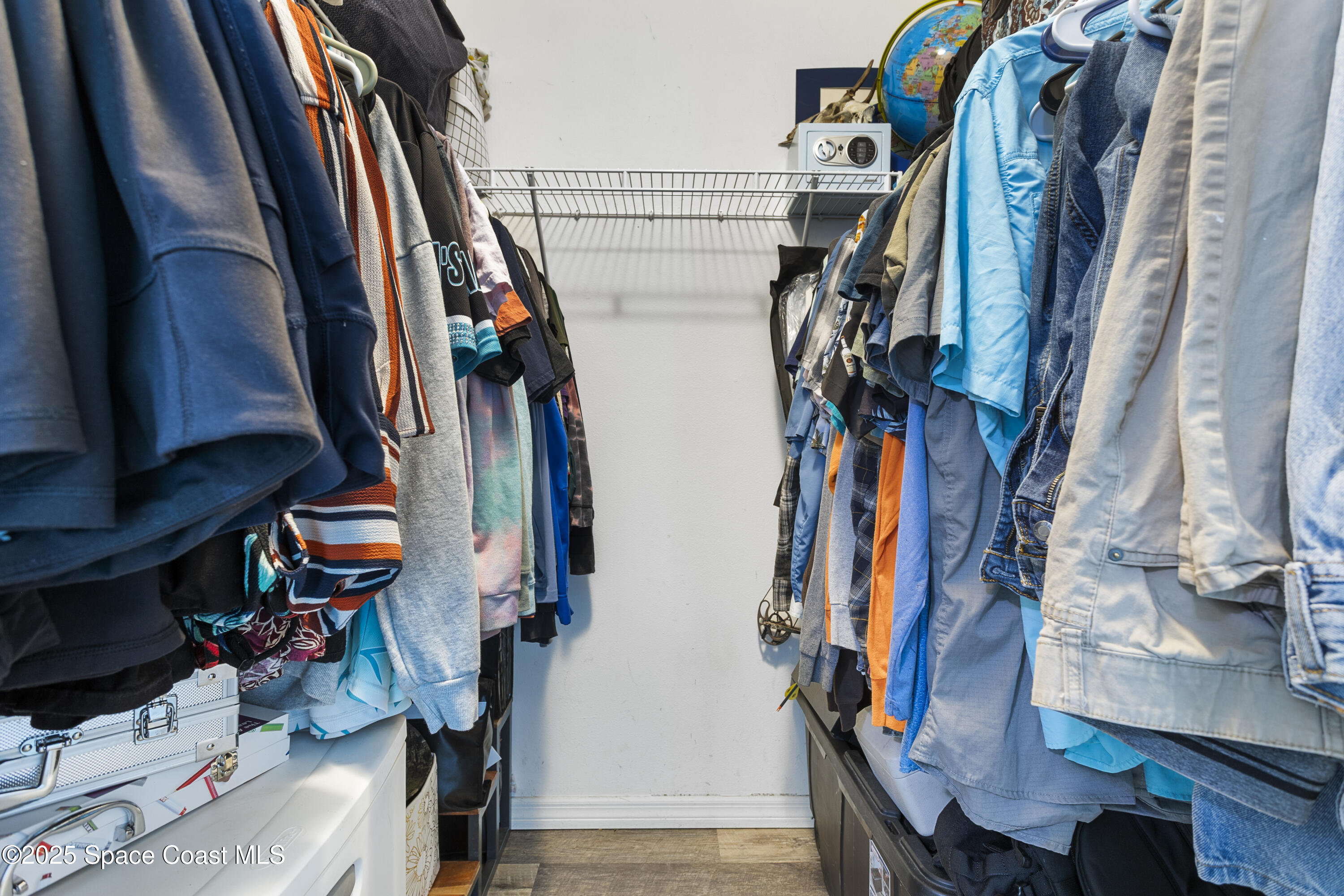 5964 Travis Street Mims, FL 32754 - Photo 18 of 45 a view of walk in closet with clothes and shoes