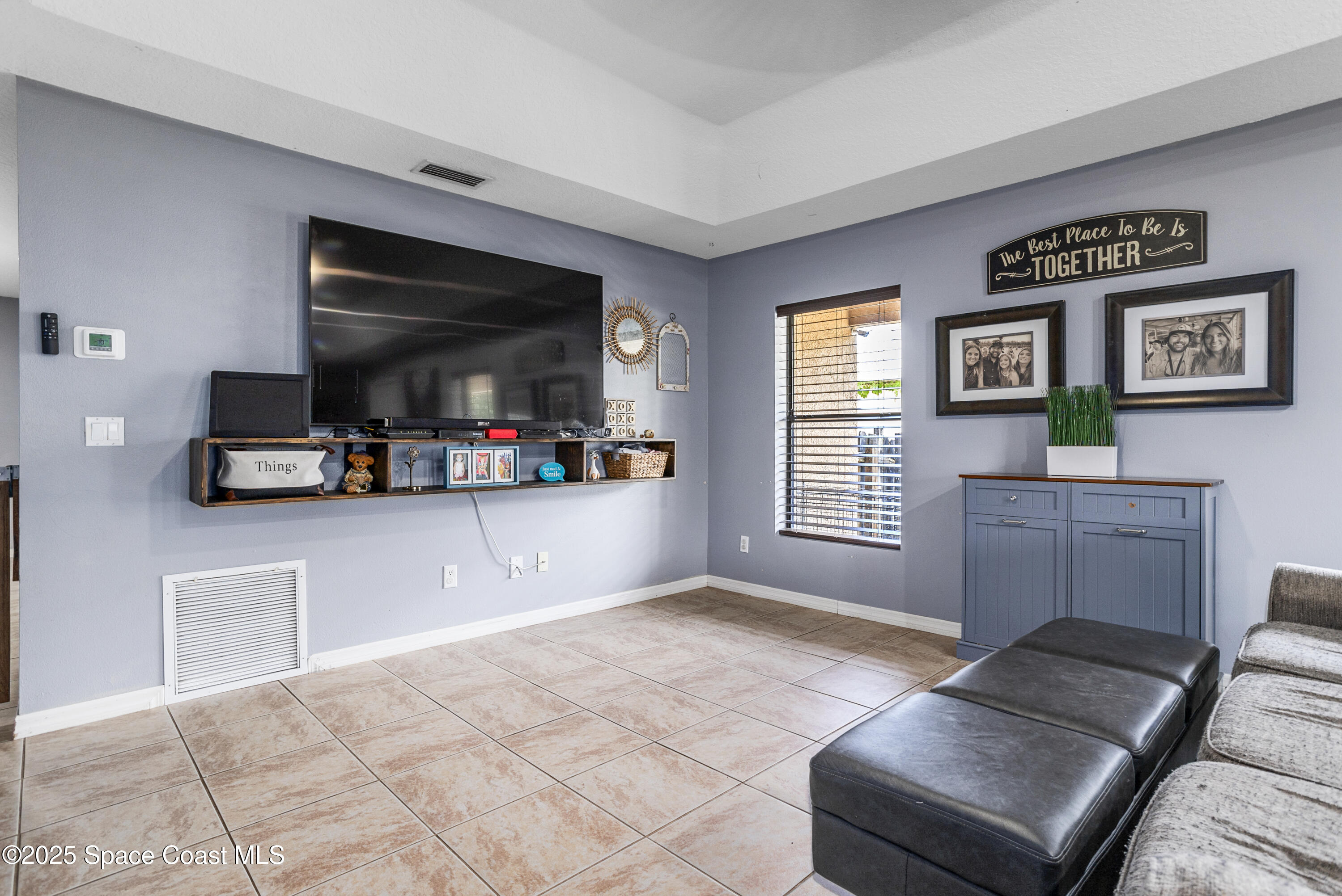 5964 Travis Street Mims, FL 32754 - Photo 20 of 45 a living room with furniture and a flat screen tv
