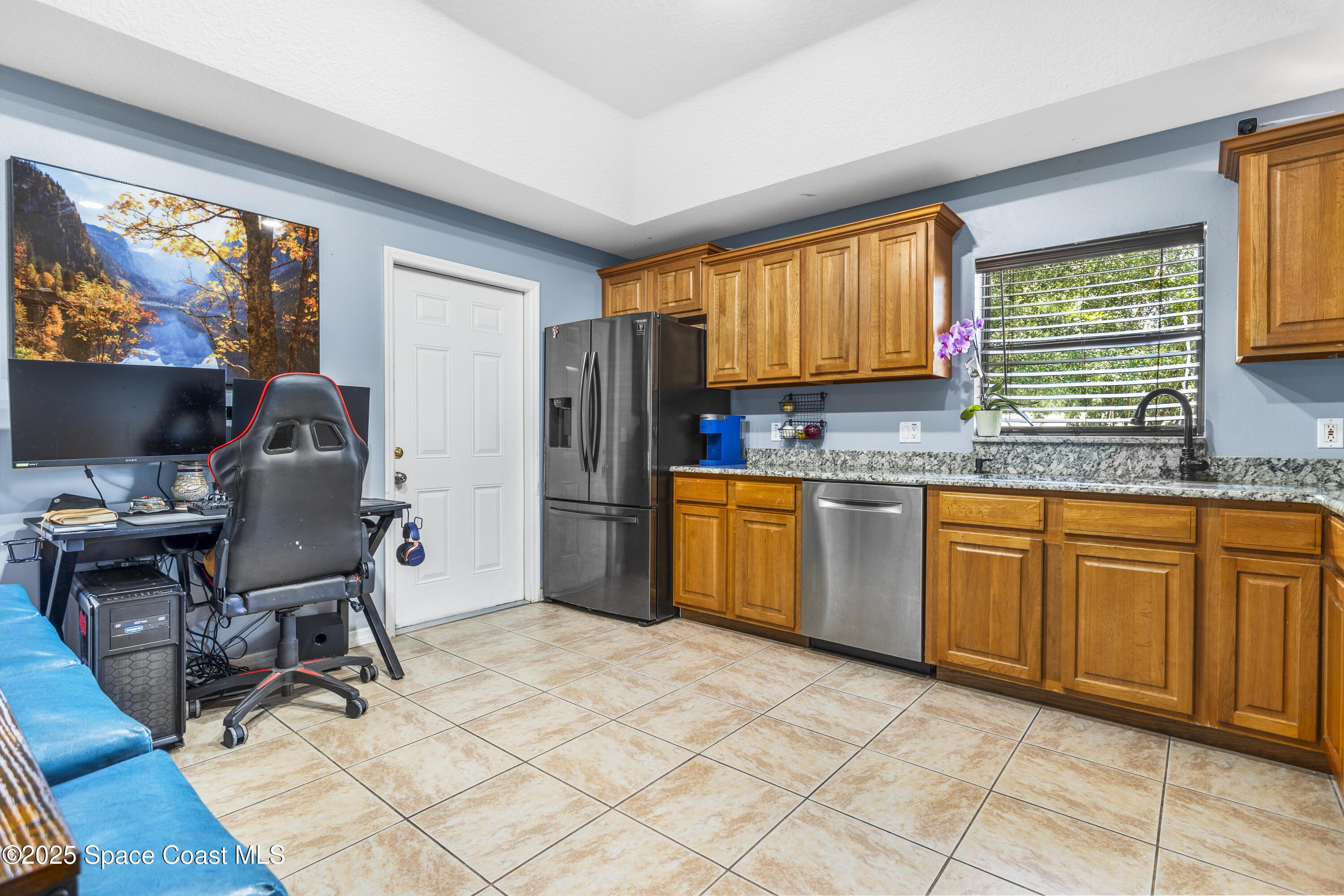 5964 Travis Street Mims, FL 32754 - Photo 24 of 45 a kitchen with a sink appliances cabinets and a window