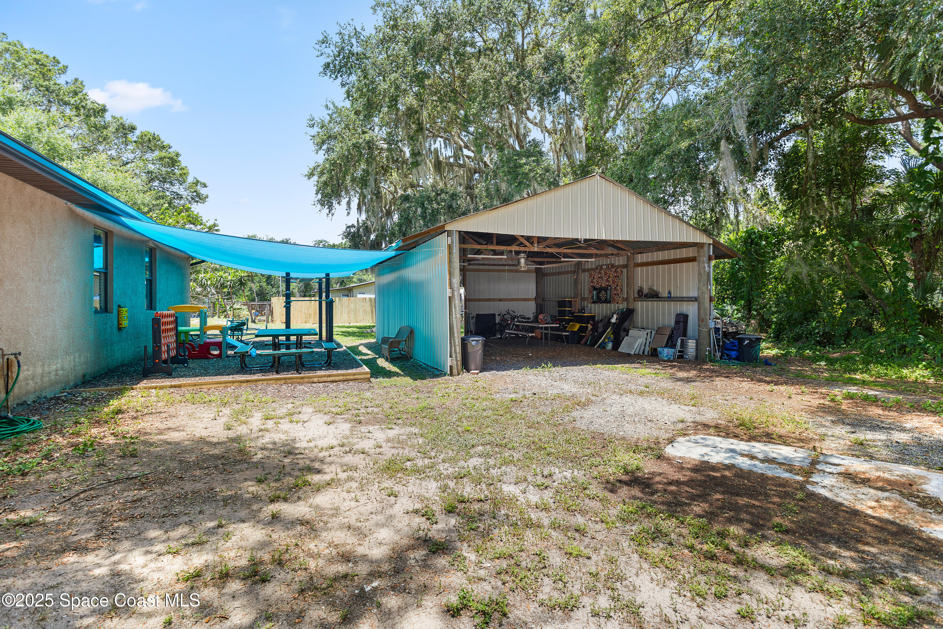 5964 Travis Street Mims, FL 32754 - Photo 27 of 45 a wooden bench sitting in front of a house