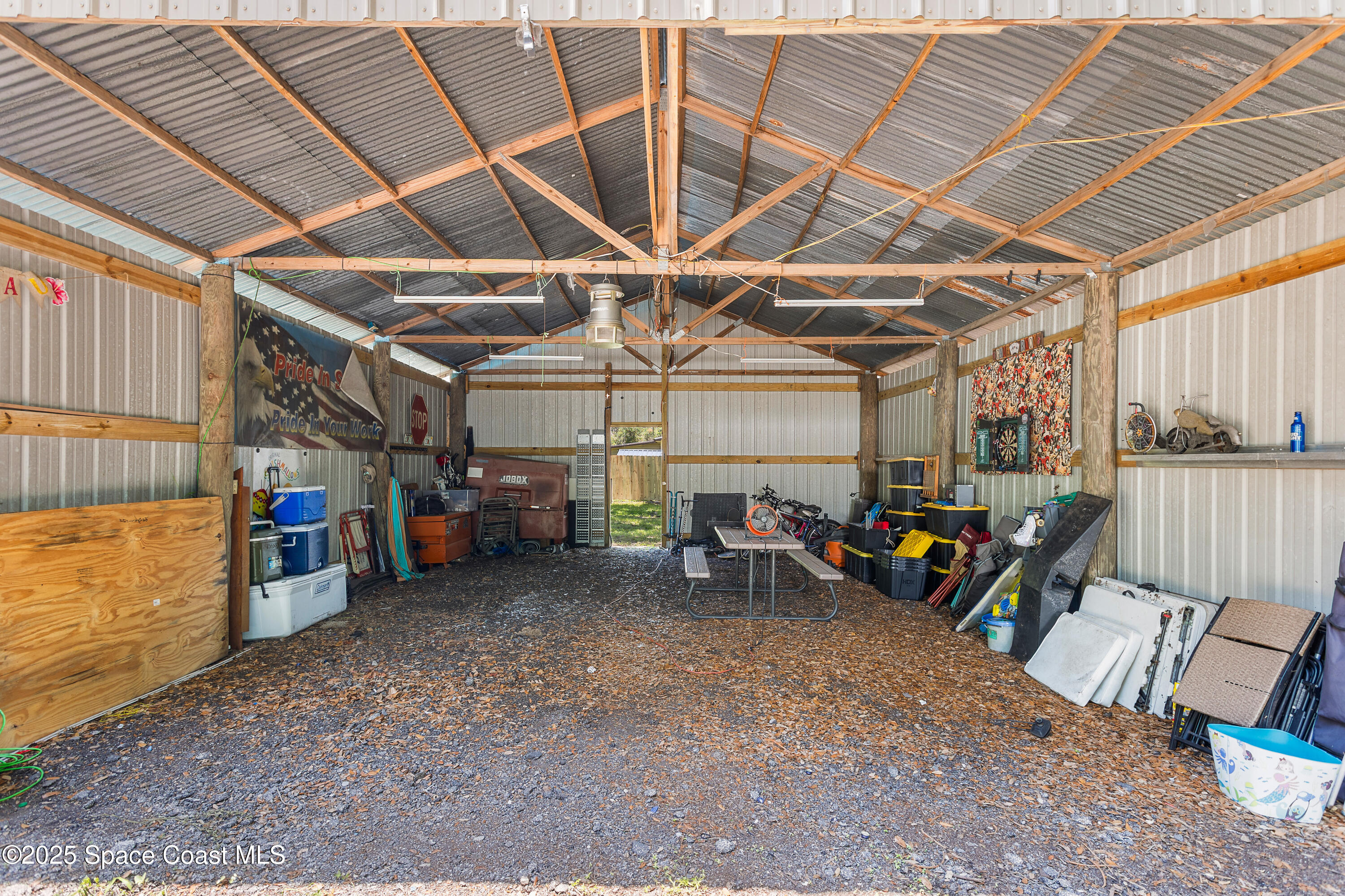 5964 Travis Street Mims, FL 32754 - Photo 30 of 45 a view of a garage with a table and chairs