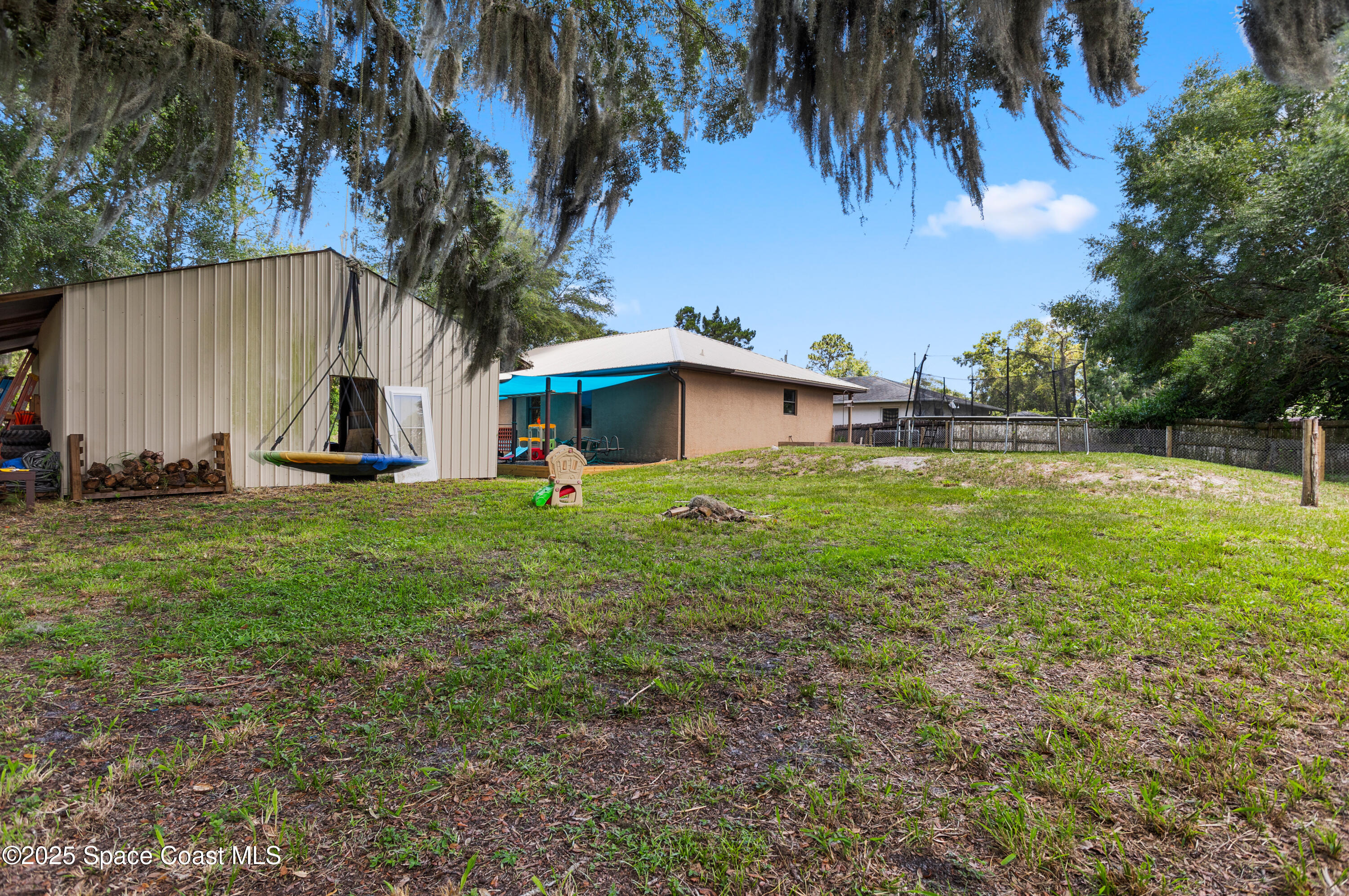 5964 Travis Street Mims, FL 32754 - Photo 32 of 45 a view of a house with a yard