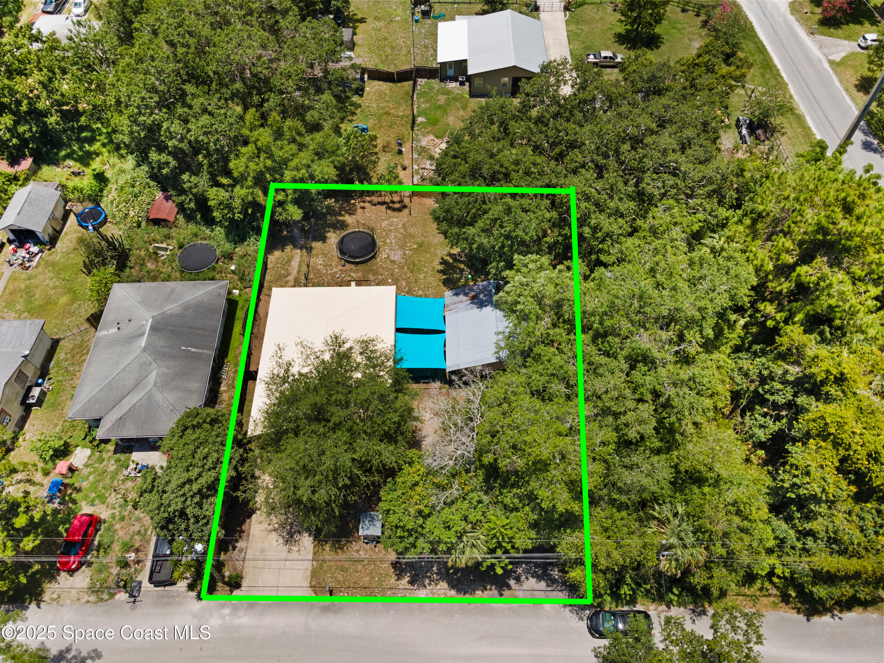 5964 Travis Street Mims, FL 32754 - Photo 37 of 45 an aerial view of a house with a yard and garden