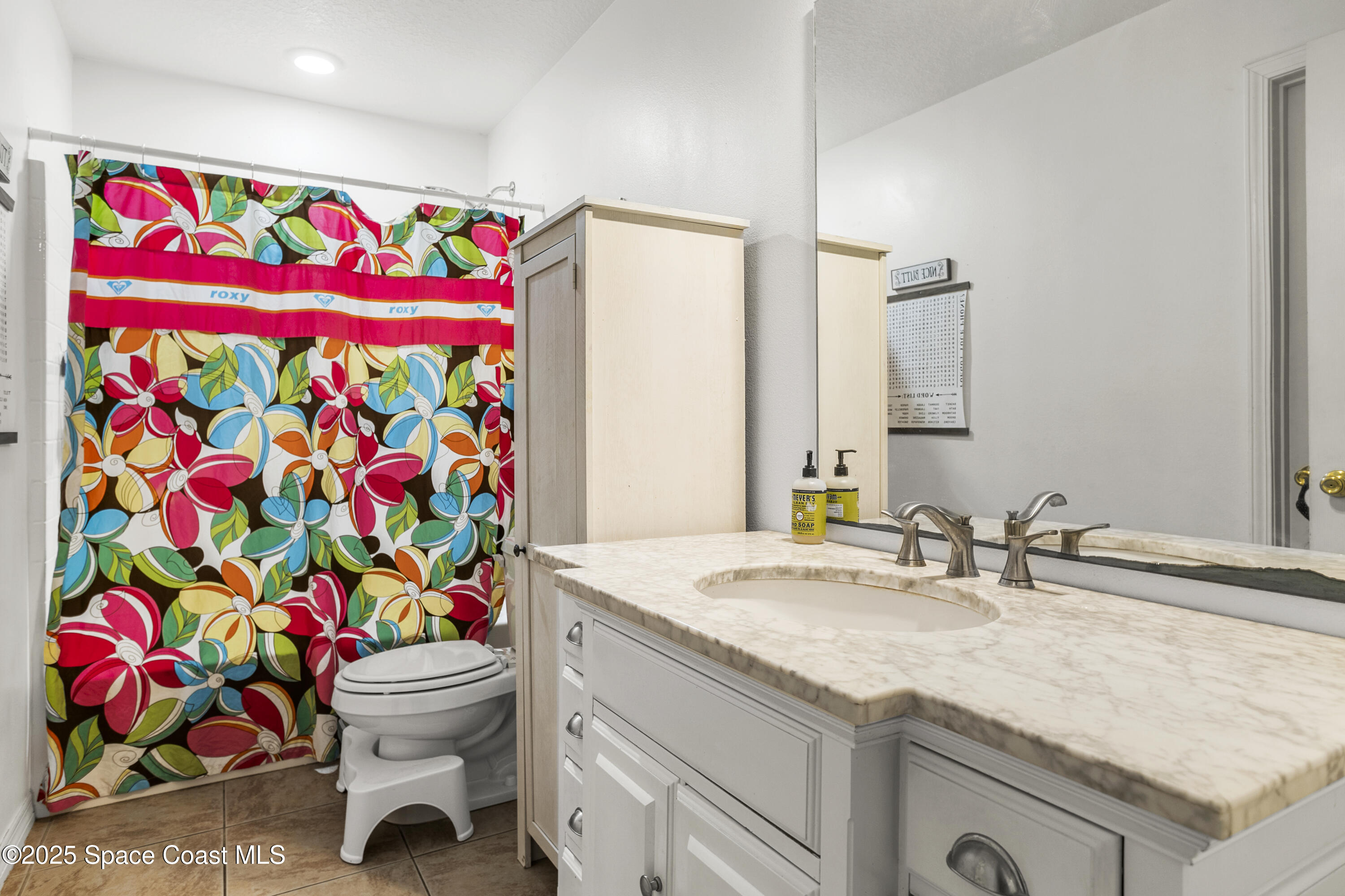 5964 Travis Street Mims, FL 32754 - Photo 9 of 45 a bathroom with a sink mirror vanity and toilet