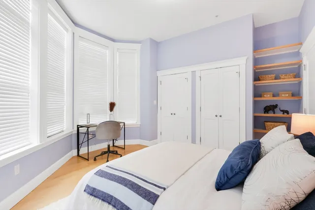 a bedroom with a bed and a chair in it